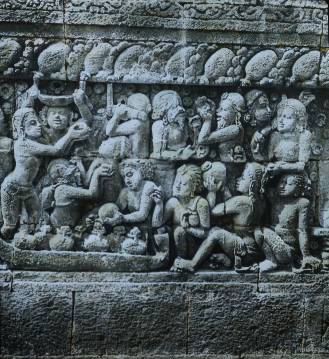 Handcolored stone relief of carved figures gesturing and holding vessels