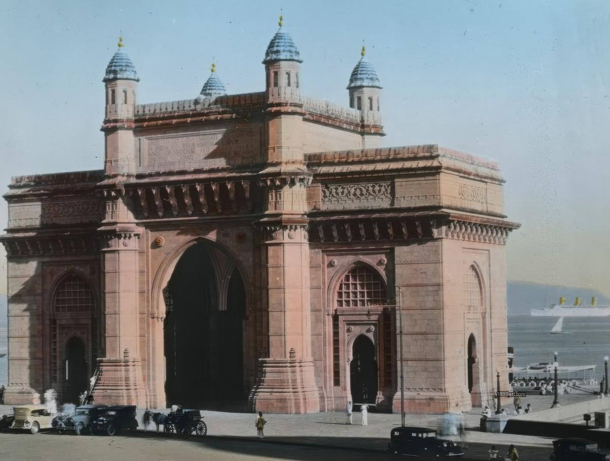 Gateway of India with vintage cars, horse-drawn carriages, and a ship