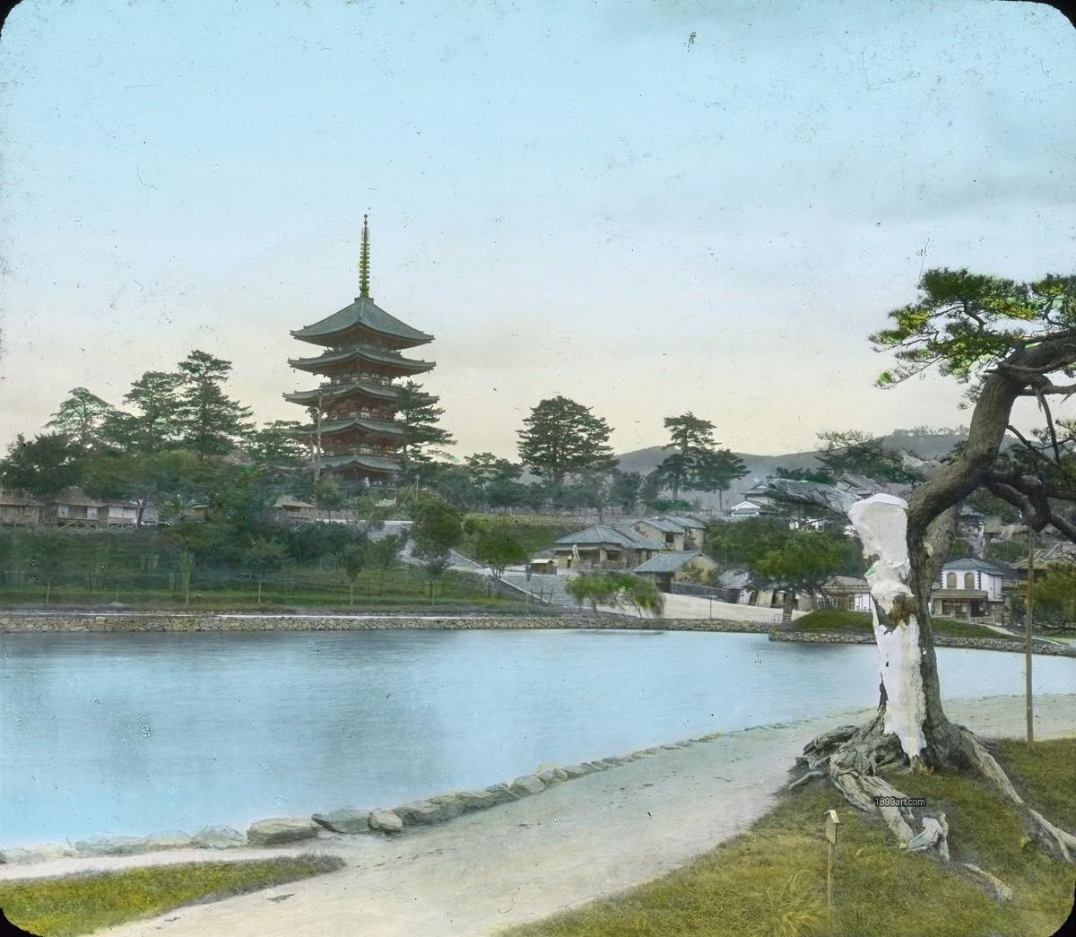 Five-story pagoda by a pond with winding path and trees