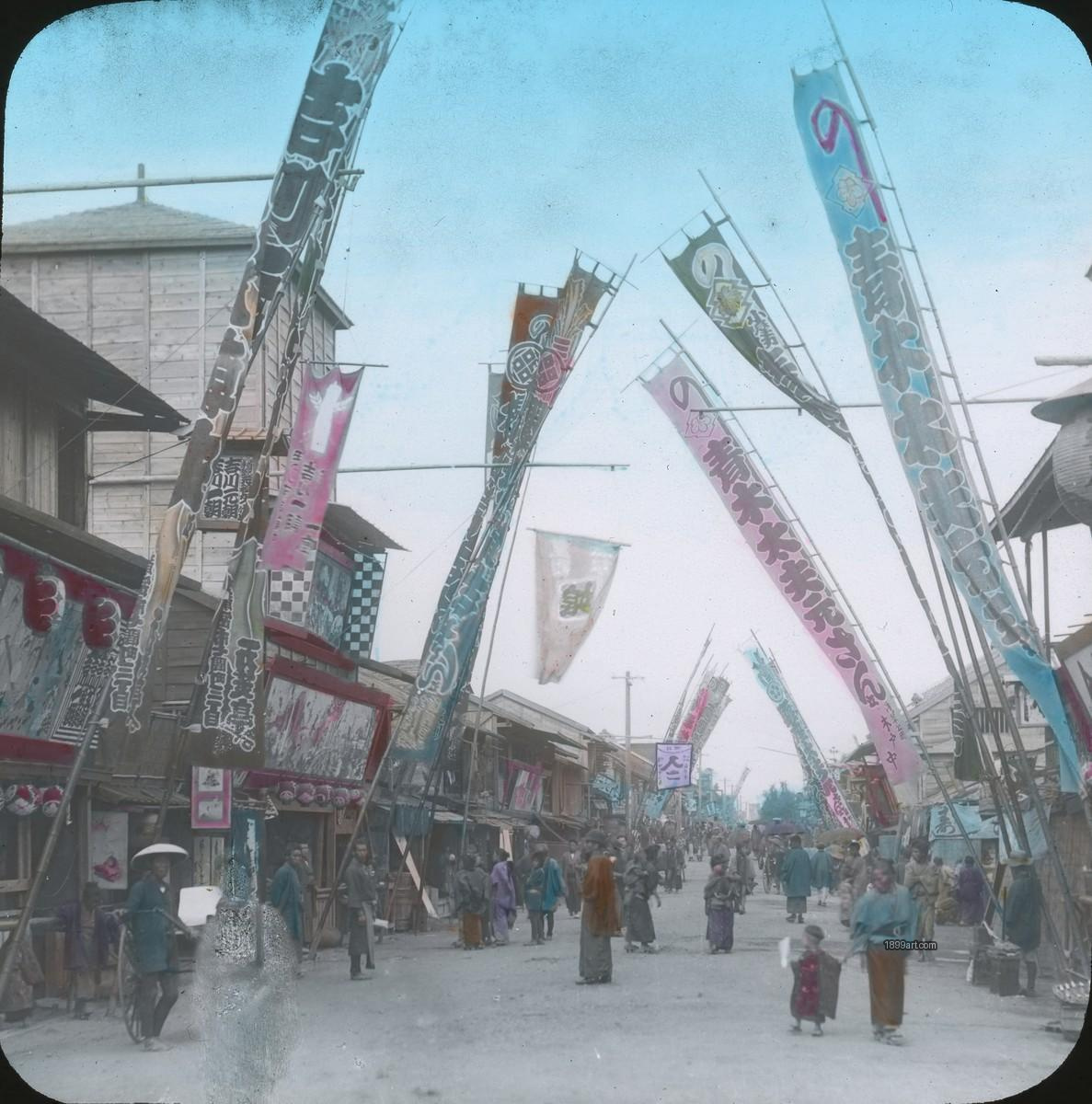 Banners line a street as people in traditional clothing gather