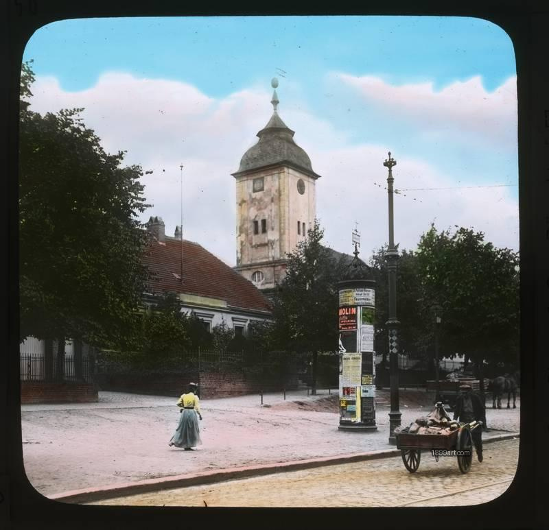 1899art Alte Kirche Schoeneberg Litfass Saeule Handkarren Handcolored 1900s 1899art. Historical photograph from the 1899art Archive.