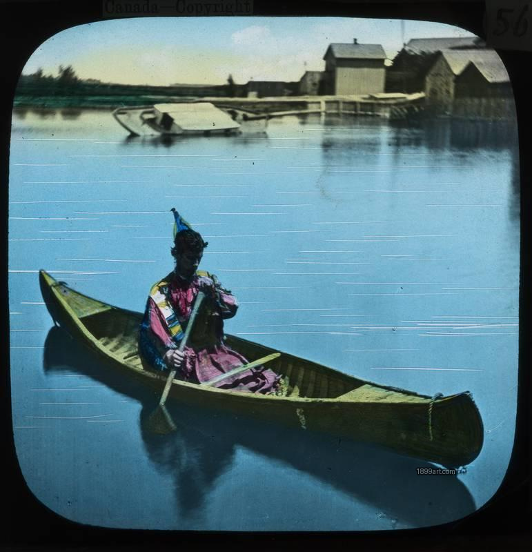 1899art Canada Canoe Costumed Figure Lakeside Settlement Hand Colored Glass Slide Handcolored 1900s 1899art. Historical photograph from the 1899art Archive.