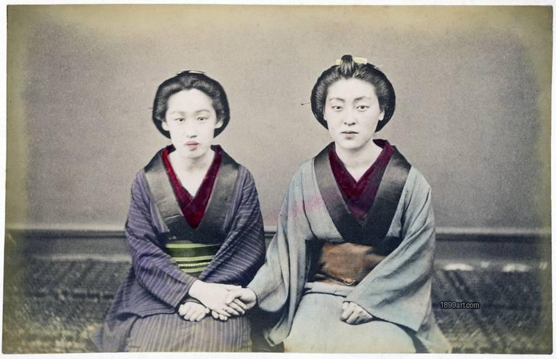 1899art Two Meiko Seated Together – Formal Studio Portrait, Japan (Meiji Period, c. 1890s) Handcolored 1900s 1899art. Historical photograph from the 1899art Archive.